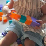 A toddler playing with blocks