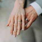 A male and female hand showing their wedding rings