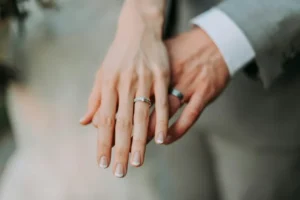 A male and female hand showing their wedding rings
