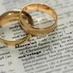 Two wedding rings on the page of a dictionary