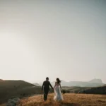 A couple just married stood on a hillside