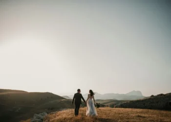 A couple just married stood on a hillside