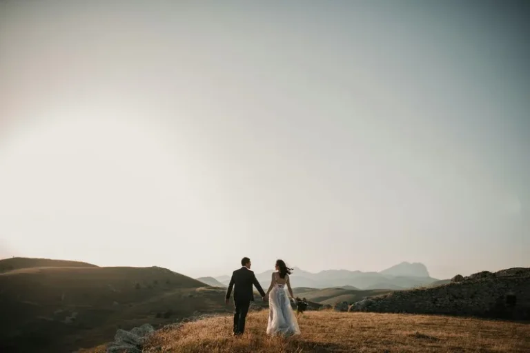 A couple just married stood on a hillside