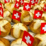 A collection of bread rolls with swiss flags in them