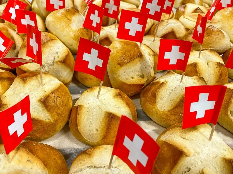 A collection of bread rolls with swiss flags in them
