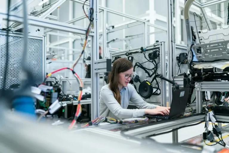 A woman in technology working at a bench