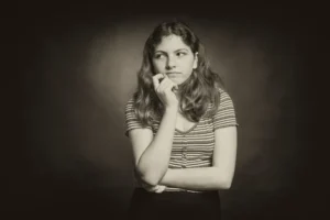 A sepia image of a woman thinking cognitively