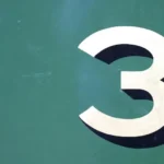 The number 3 with shadow against a green background