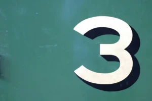 The number 3 with shadow against a green background