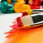A paint brush with orange paint