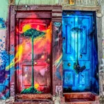 Two brightly painted front doors with trees on
