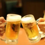 Two beer glassing clinking.