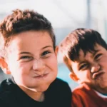 Two boys pulling ridiculous faces