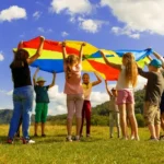A group of children with a large flag on a sunny day