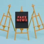 three minature easels with the middle one saying fake news