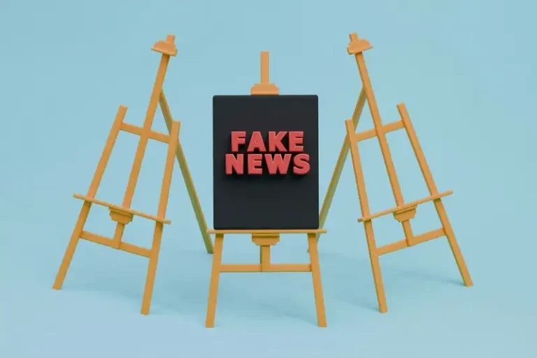 three minature easels with the middle one saying fake news