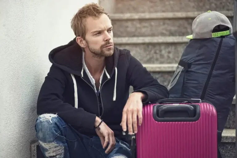 A man with a purple suitcase experiencing divorce