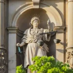 A statue of justice with scales in one hand and sword in the other