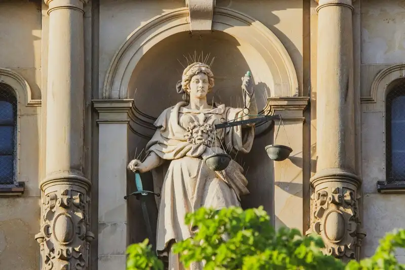 A statue of justice with scales in one hand and sword in the other