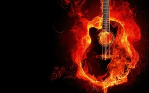 A guitar surrounding by the flames of power by a music producer