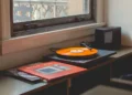 A record player playing an orange vinyl