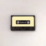 A cassette tape with a yellow label