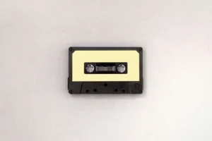 A cassette tape with a yellow label