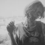 A model dressed as a zombie in black in white