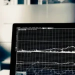 A laptop displaying data graphs