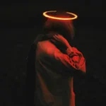 A person in the dark with a glowing halo