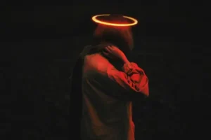 A person in the dark with a glowing halo