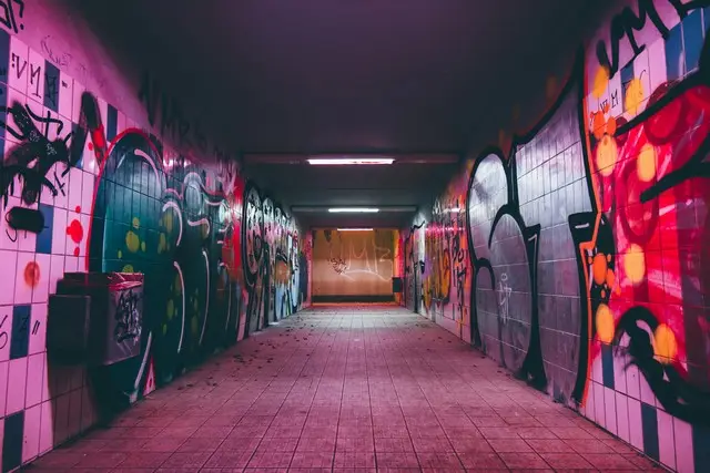 An underpass covered in urban graffitti