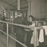 A historical photo showing people in an immigration queue
