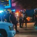 Armed riot police at night
