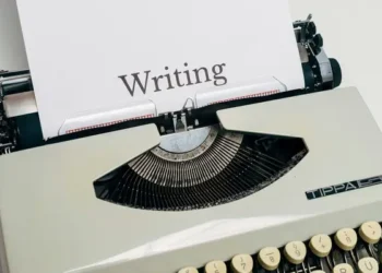 A typewriter with a paper saying 'writing'