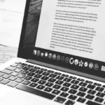 A laptop displaying an essay