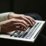 Typing an essay on a laptop