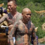 Bare-chested yakuza displaying their tattoos