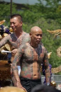 Bare-chested yakuza displaying their tattoos