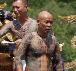 Bare-chested yakuza displaying their tattoos