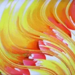 An abstract art piece resembling wavy pages of a book in reds, yellows, and oranges.