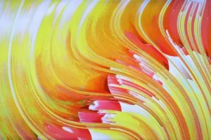 An abstract art piece resembling wavy pages of a book in reds, yellows, and oranges.