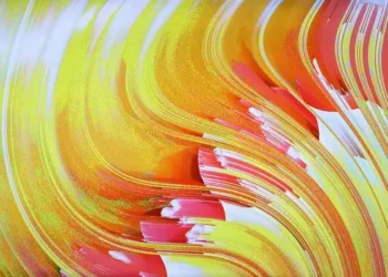An abstract art piece resembling wavy pages of a book in reds, yellows, and oranges.