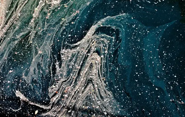 An abstract space-like image with waves of white paint