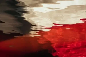 Abstract black, red, and white paints.