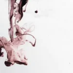 An abstract dark red splash against a white and grey background