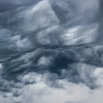 Abstract liquid grey swrils in water resembling dark grey clouds