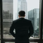 A corporate geezer looking out his office window