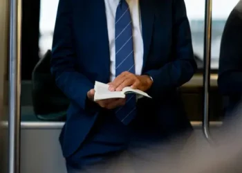 A manager leafing through pages of his book