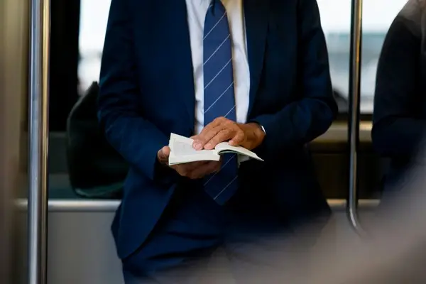 A manager leafing through pages of his book